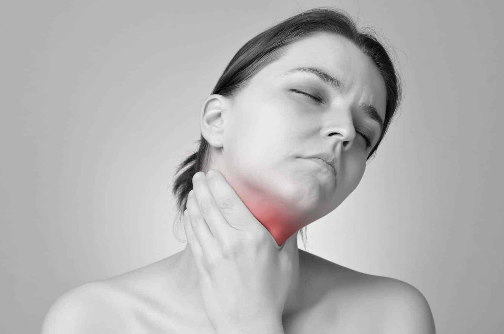 woman touching her thyroid